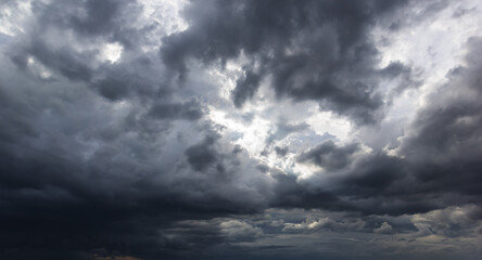 The dark sky with heavy clouds converging and a violent storm before the rain.Bad or night weather...