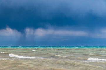 Thunderclouds over Issyk-Kul. Rain on the lake.