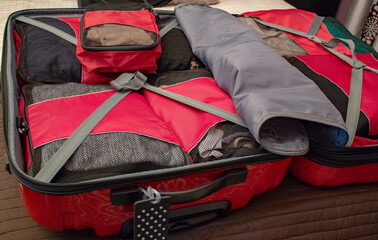 An open suitcase with packing organizers. Packing for vacation. Packing bags or cubes.