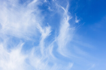 Blue sky with white cirrus clouds on a windy sunny day