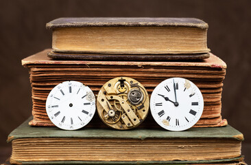Old books and antique clock faces. Story book, storytelling, time background.