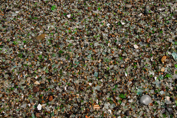 Background of small sea pebbles in the color of multicolored glass, top view.