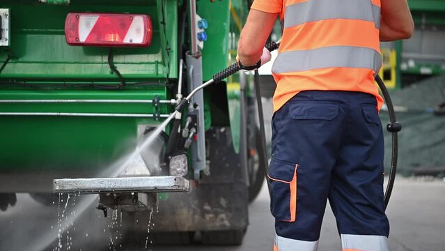 Garbage Truck Washing by Pressure Washing Worker
