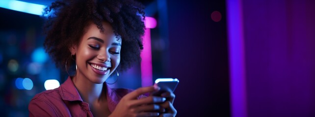 Stylish American African woman smiling and holding smart phone reading messages from her friends, neon light club background, with copy space, concept for hang out with friends, relax in bar, party.