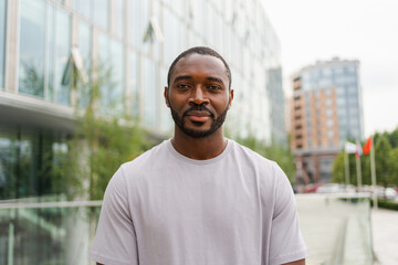 Happy african american man smiling outdoor. Portrait of young happy man on street in city. Cheerful...