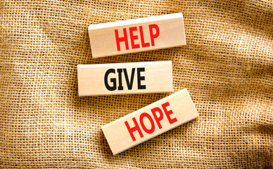 Help give hope symbol. Concept word Help give hope on beautiful wooden block. Beautiful canvas table canvas background. Business motivational help give hope concept. Copy space.