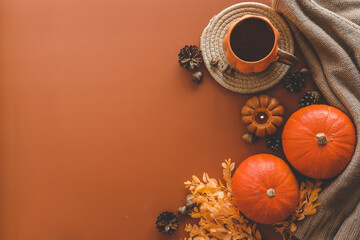 Autumn background top view, pumpkin and leaves on orange background