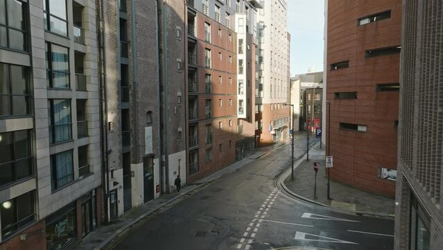 Elevated sweep of Liverpool's bustling city center and hidden alleys.
