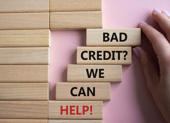 Bad credit We can Help symbol. Wooden blocks with words Bad credit We can Help. Beautiful pink...