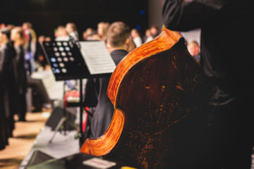 Concert view of violoncello player with vocalist and musical orchestra band, during jazz concert,...