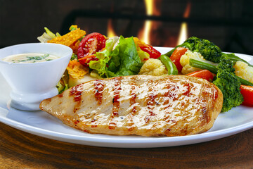 Grilled chicken steak with salad and vegetables