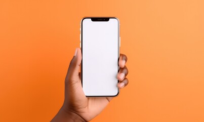 Black hand holding phone isolated on orange background. Blank screen, phone screen mockup, front view, clipping path, clipping mask. - obrazy, fototapety, plakaty