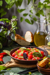 Spicy salad of fresh watermelon balls with basil, lime, rosemary and fennel, topping with olive oil