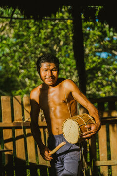 Local man playing drum in sunlight