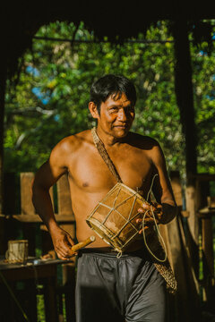 Local man playing drum in sunlight