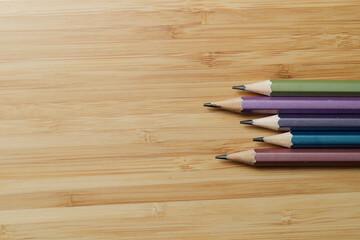 Obraz premium top view of various pencils on wood