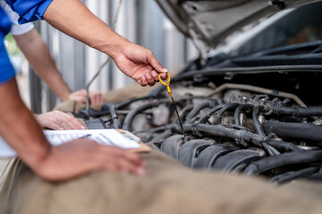 Specialist mechanic supervisor engineer gasoline automotive repairing car in garage.