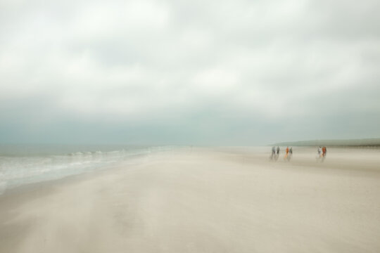 blurred photo of family on the beach