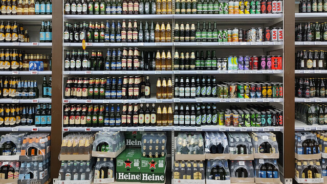 Kyiv, Ukraine - 4 September, 2023: Inside the Auchan supermarket. Showcase with beer alcohol in assortment.