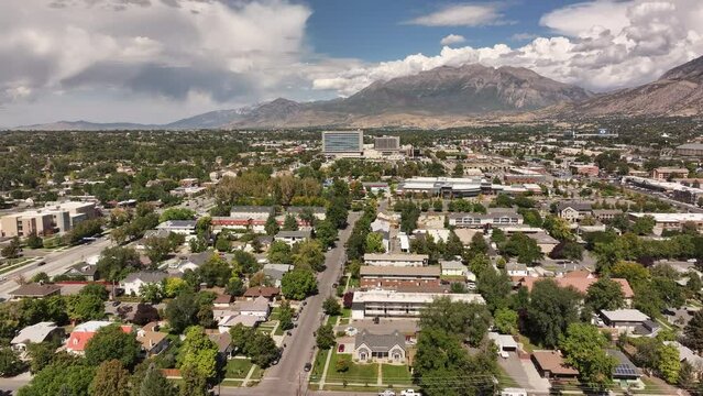 Aerial Provo Utah downtown homes hospital 4K. Aerial Provo Utah downtown business shopping building. Urban city office, buildings business headquarters along street traffic. Neighborhood.