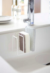 sponge for washing dishes on the rack in kitchen interior