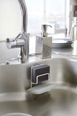Close up of steel sink and faucet in kitchen interior