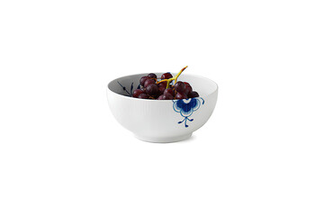 Fresh black grape in white ceramic bowl, isolated on white
