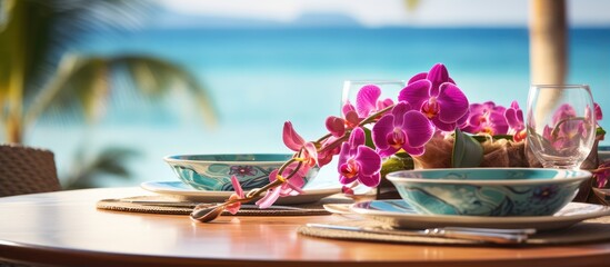 Oceanfront resort restaurant with tropical table decor and orchids