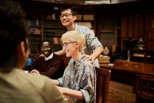 Young and diverse group of college students studying in a college library together