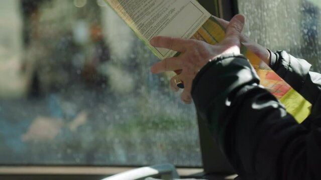 tourist watching Paris city map on a bus ride