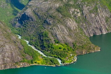 Tranquil lake surrounded by beautiful lush green mountain