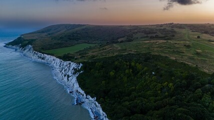 Aerial view of green coastal hills in England at sunset