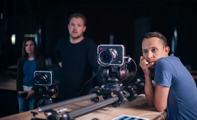 Director of photography with a camera in his hands on the set. Professional videographer at work on filming a movie