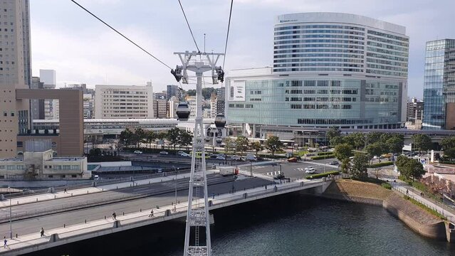 Aerial view of a cable car, gondola over a river with cityscape in YQokohama city, Japan