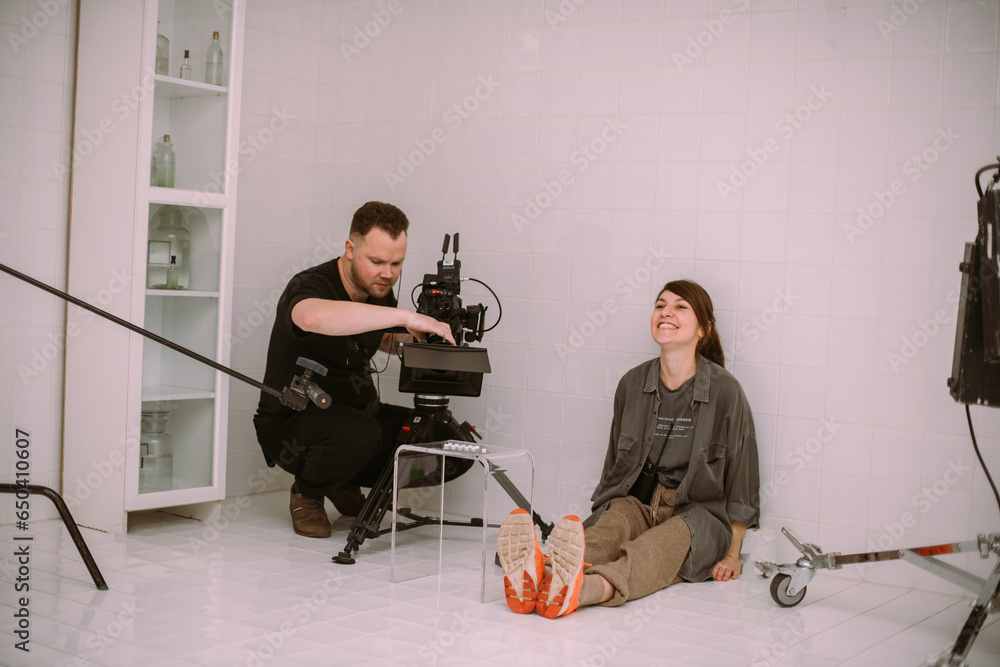 Wall mural director of photography with a camera in his hands on the set.