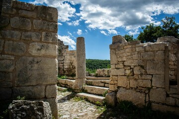 ruins in an ancient country under blue sky and clouds, in an ancient village near