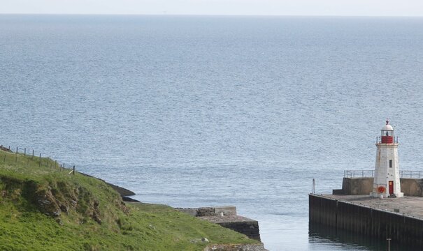 Scenic view of a small lighthouse located at the edge of a body of water in Lybster, Scotland
