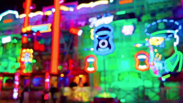 Electrifying Night: Neon Amusement Park Lights Up the Dark