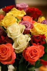 Vase filled with vibrant a bouquet of vibrant and colorful roses