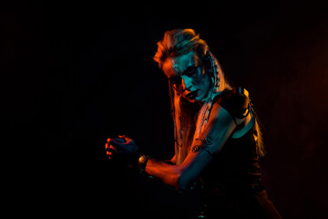 Profile photo of mysterious brave valkyrie myth war woman painted body face isolated on black background
