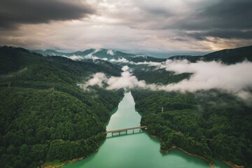 Fototapeta premium Aerial view of a tranquil landscape with river winding through it under the sunlit morning sky