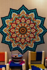 Room with a vibrant mandala art display on one wall