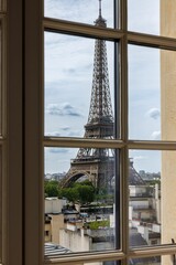 Window with a stunning view of the iconic Eiffel Tower in Paris, France