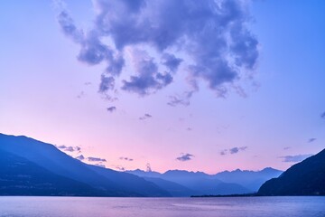 Naklejka na ściany i meble Beautiful shot of a sunset sky over Lake Como and nearby mountains