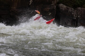 Adventurous kayaker navigating the challenging rapids of the Gauley River in West Virginia