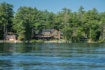 Fototapeta na wymiar Picturesque lake house in front of the peaceful waters of Lake Winnipesaukee, New Hampshire
