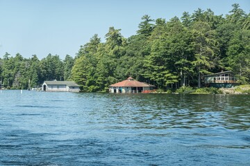 Fototapeta na wymiar Scenic view of houses perched near New Hampshire Lake Winnipesaukee surrounded by lush greenery