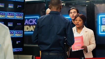 Mad diverse people in line on black friday seasonal sales, arguing with security agent to allow...