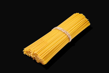 Bunch of spaghetti tied with rope isolated on black