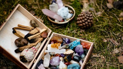 Closeup of crystal stones, pine cones, and wooden sticks for rituals